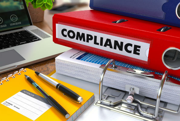 Image of binder labeled "compliance"